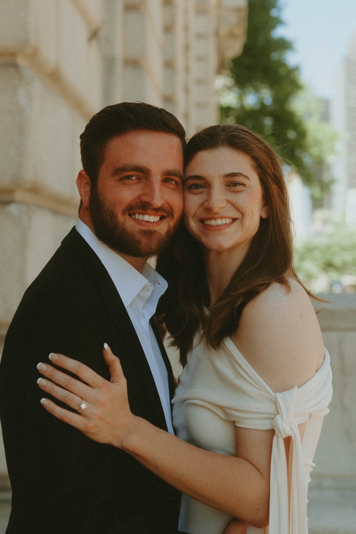 Tylar and Carly smiling together in a close portrait outdoors