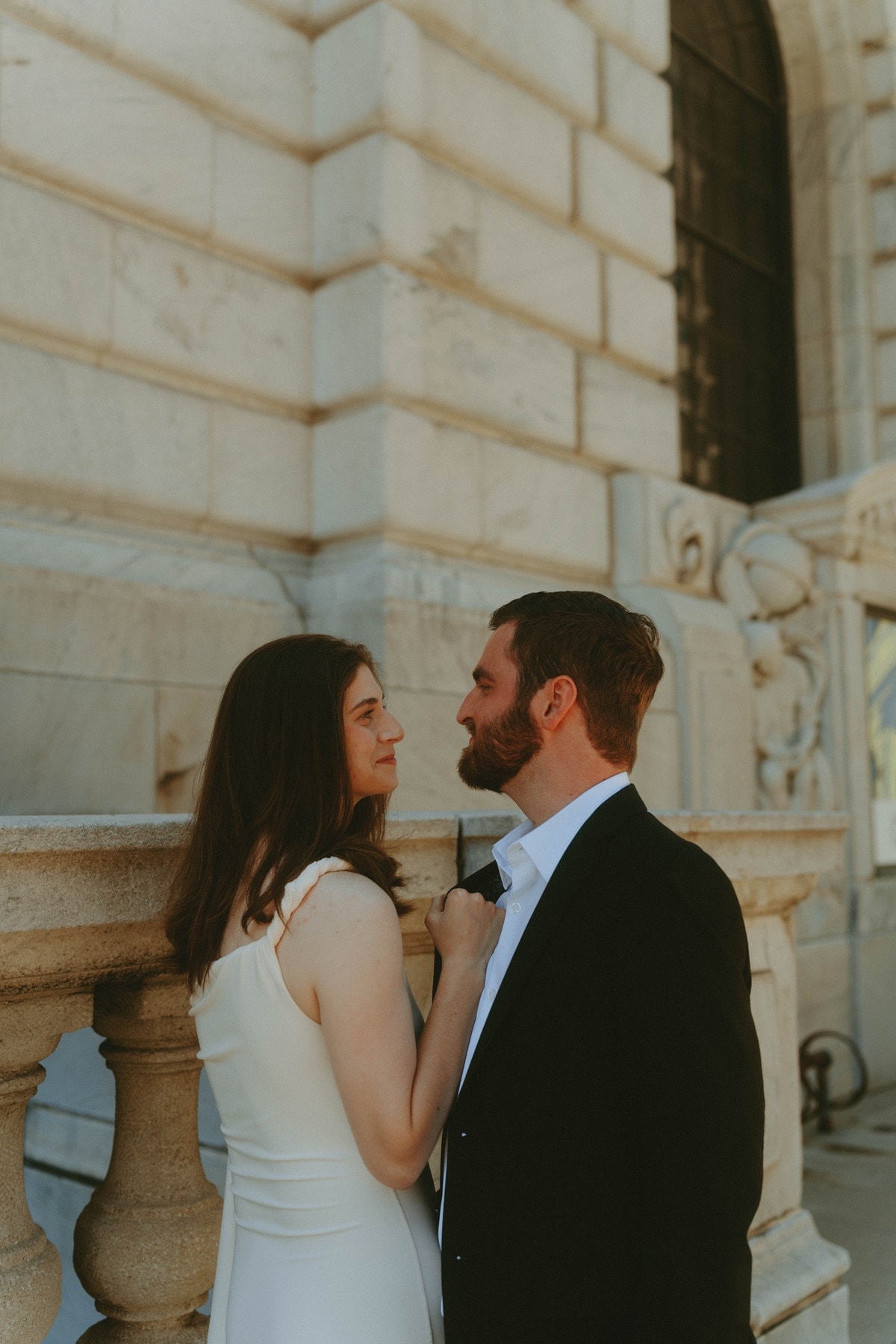 Tylar and Carly gazing at each other beside a stone balustrade