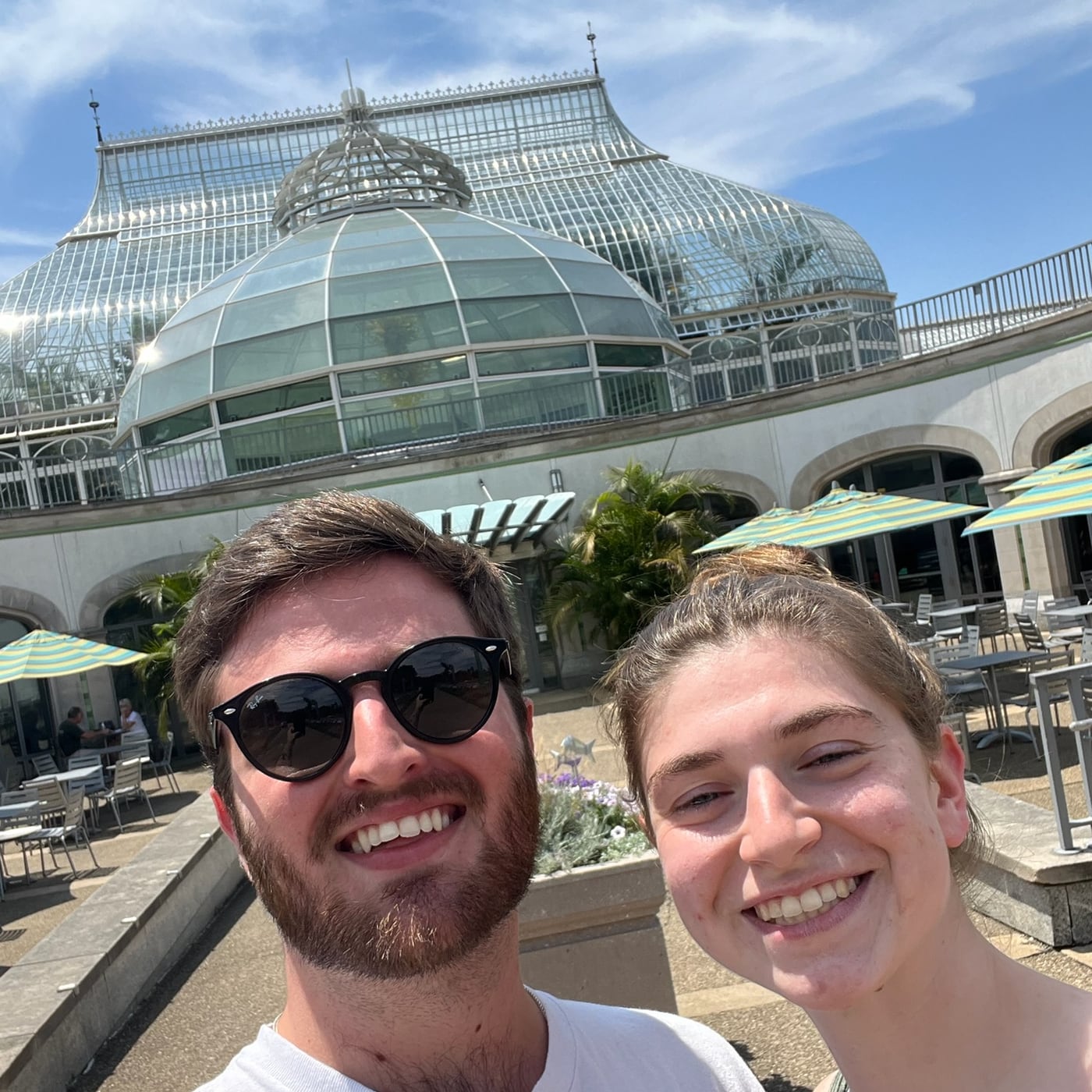 Tylar and Carly in sunglasses outside a glass conservatory