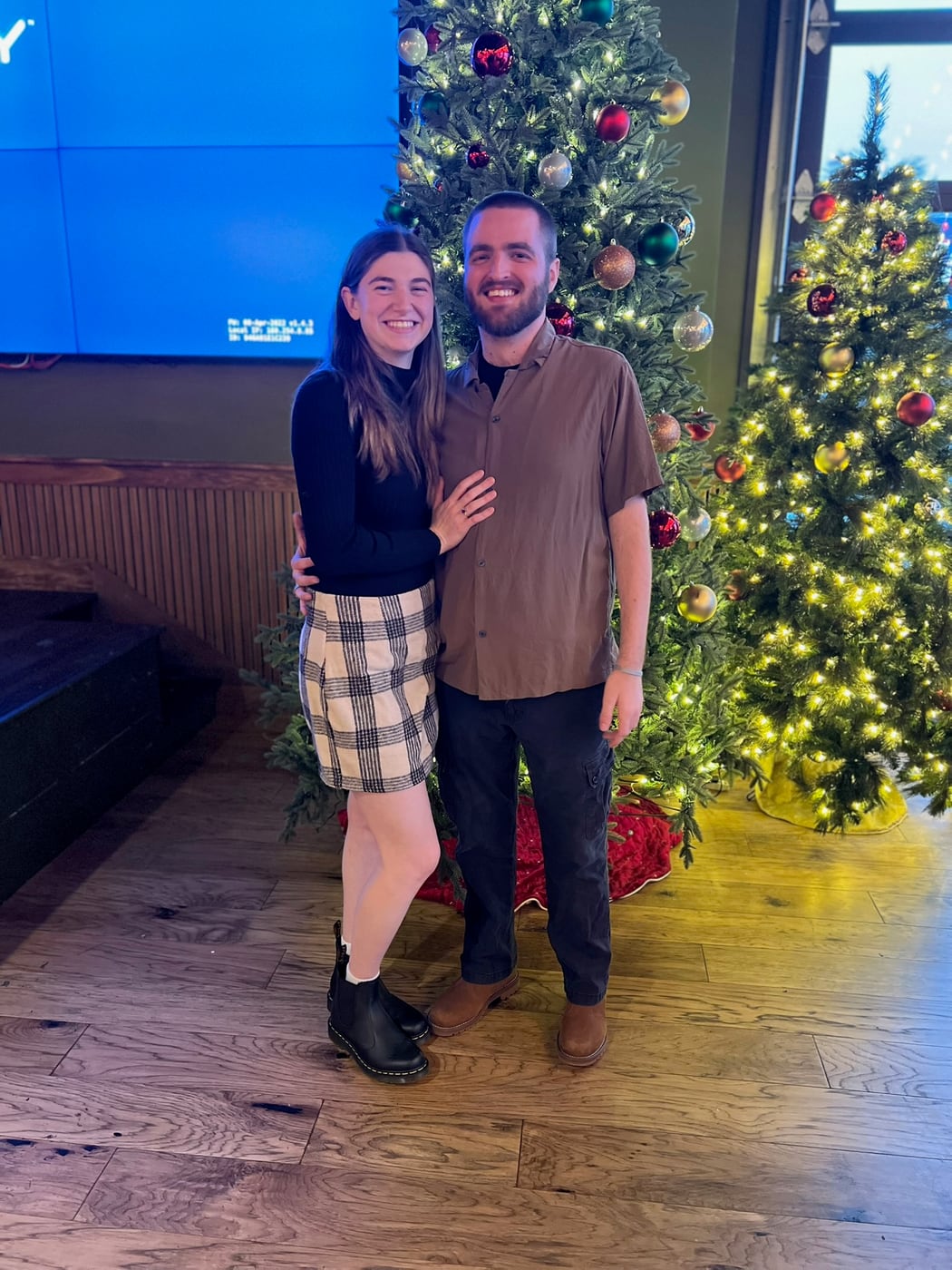 Tylar and Carly in front of a decorated Christmas tree