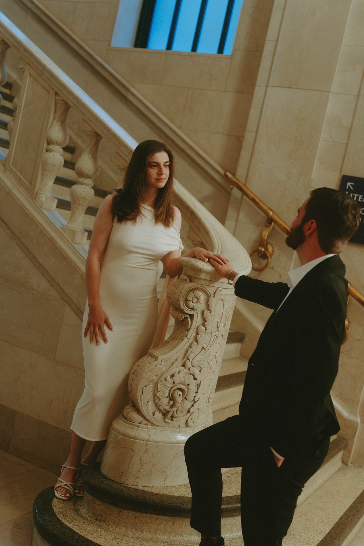 Carly posed elegantly on the staircase with Tylar standing below