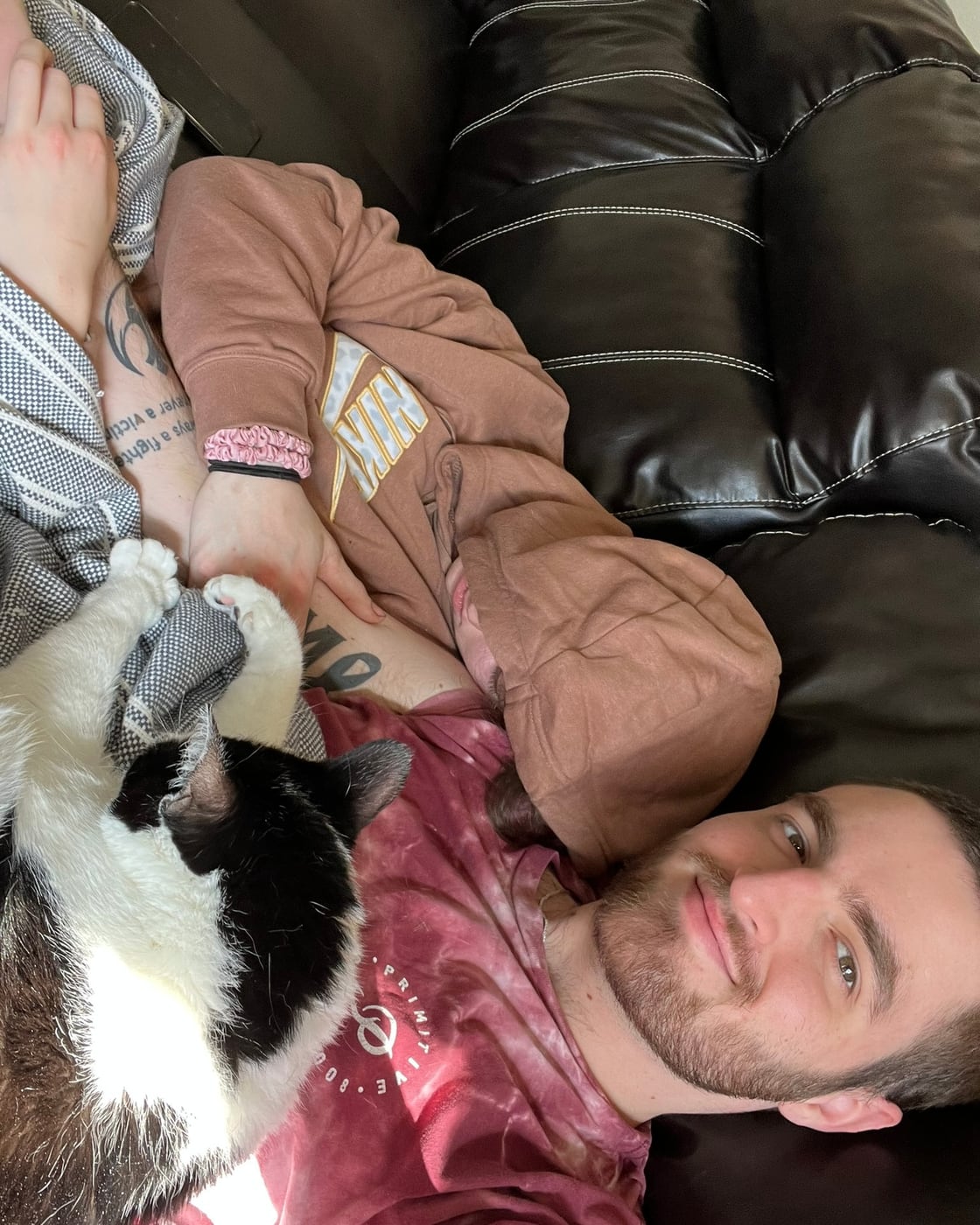 Tylar and Carly stretched out on the couch with their cat