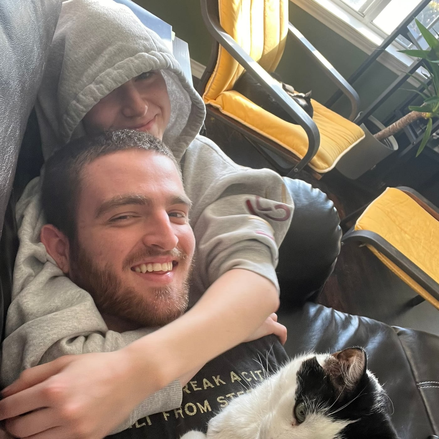 Tylar resting with the cat curled against him
